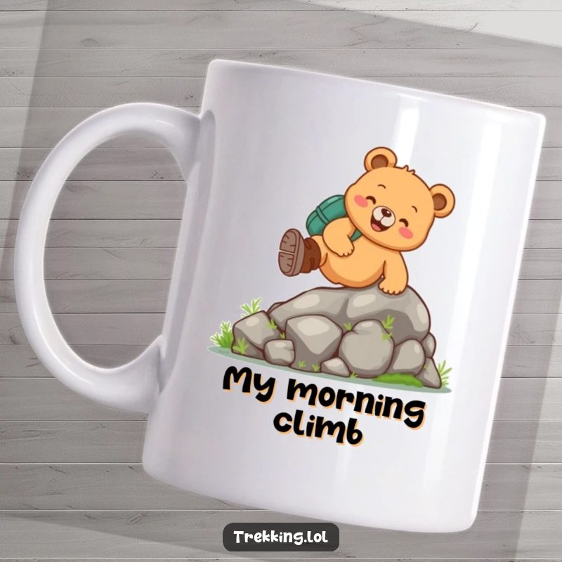 Funny hiking bear mug featuring a cheerful bear in boots climbing a mossy rock, embodying a love for the outdoors and a good chuckle.