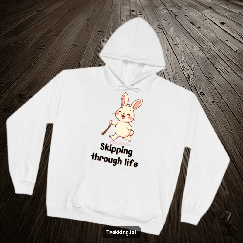 Funny hoodie featuring a cheerful rabbit joyfully skipping and holding a walking stick, designed for comfort and happy vibes.
