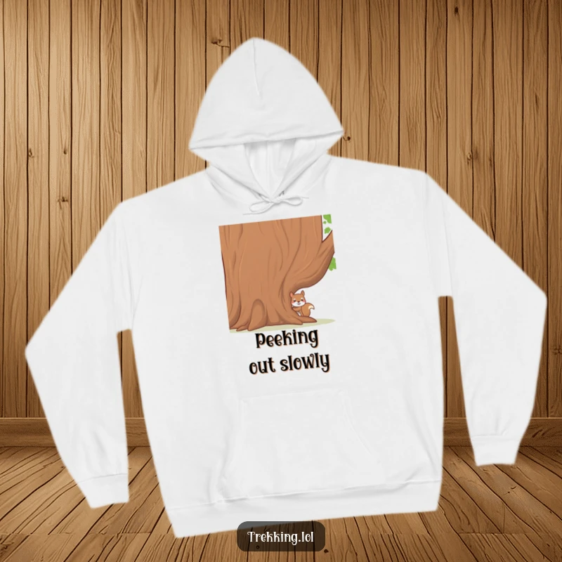 Funny hoodie with a shy squirrel peeking from behind a large, welcoming tree, offering warmth and a touch of woodland charm.