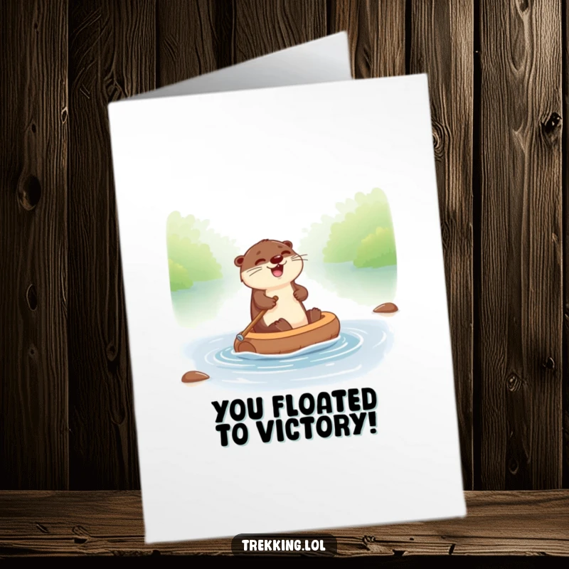 Funny free printable congratulations card: a giggling otter joyfully paddling a tiny raft down a river, signifying progress.