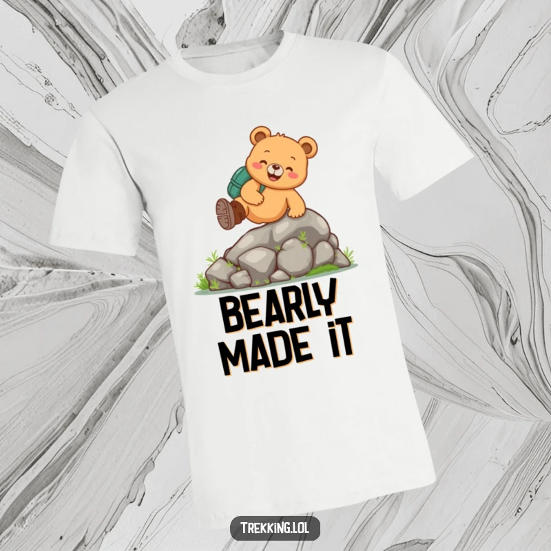 Funny bear hiking t-shirt with a cheerful bear wearing boots, joyfully climbing a small mossy rock, perfect for nature lovers.