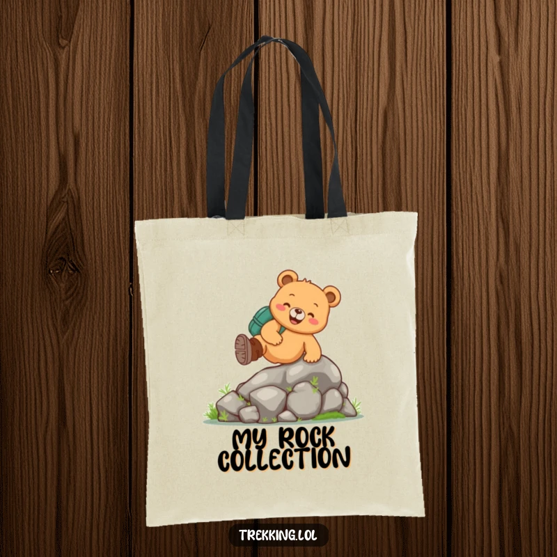 Funny bear hiking tote bag featuring a cheerful bear wearing hiking boots, climbing a mossy rock, great for eco-conscious adventurers.