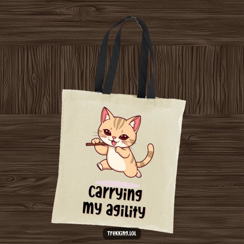 Funny tote bag featuring a determined cat mid-leap with a walking stick, perfect for carrying items with a humorous and adventurous spirit.